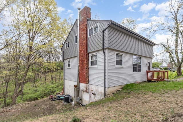 25 High St, Newport, KY 41071 - view of home's exterior with a deck, central AC, and a chimney