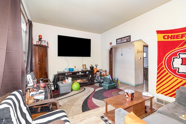 25 High St, Newport, KY 41071 - living room featuring a glass covered fireplace, visible vents, and wood finished floors