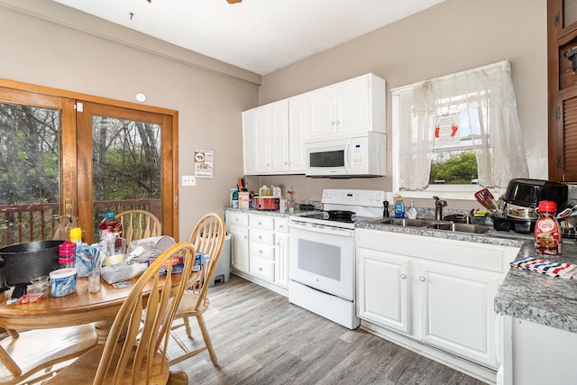 25 High St, Newport, KY 41071 - kitchen with light wood-style floors, white cabinetry, a sink, and white appliances