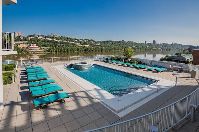 view of pool featuring a water view