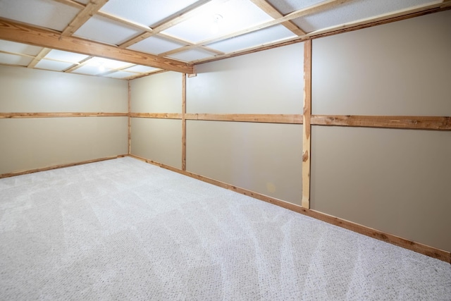 unfurnished room with baseboards and light carpet