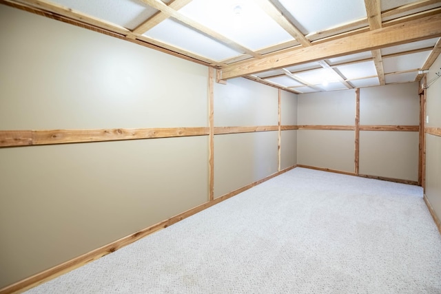 finished basement featuring light colored carpet and baseboards