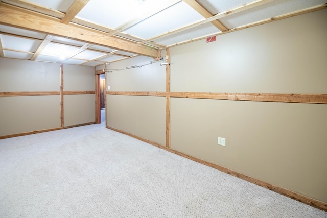 finished basement featuring baseboards and light colored carpet