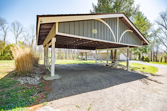 view of car parking featuring driveway and a carport