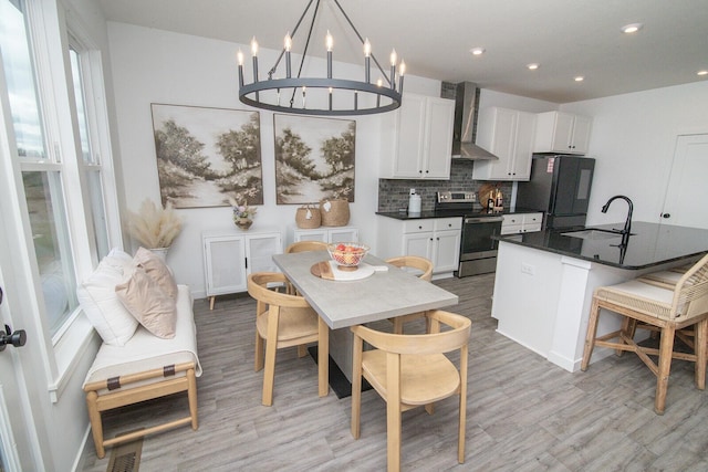 interior space with visible vents, baseboards, a chandelier, light wood-style floors, and recessed lighting