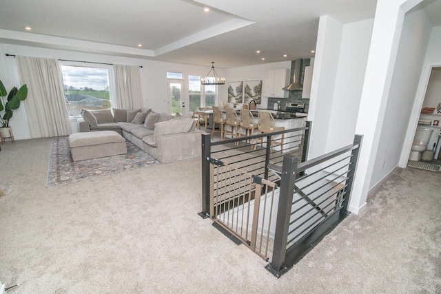 carpeted living area featuring a notable chandelier and recessed lighting