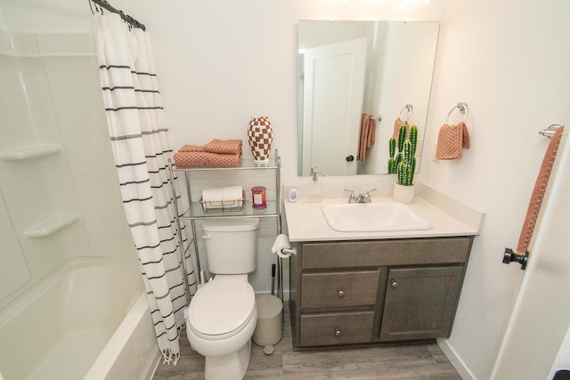 bathroom featuring toilet, wood finished floors, vanity, and shower / bath combination with curtain