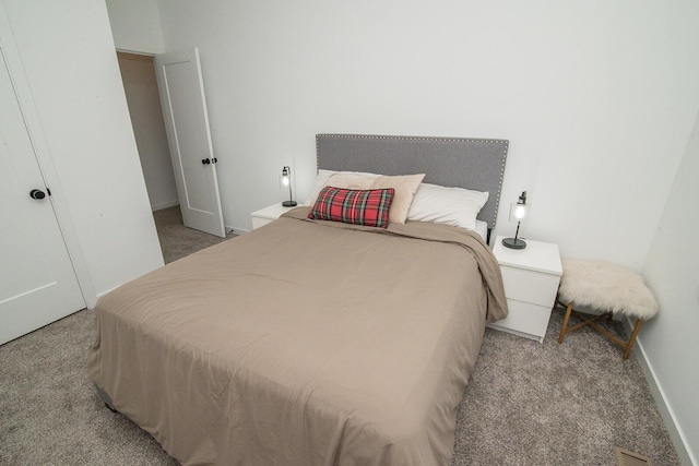 carpeted bedroom with visible vents and baseboards