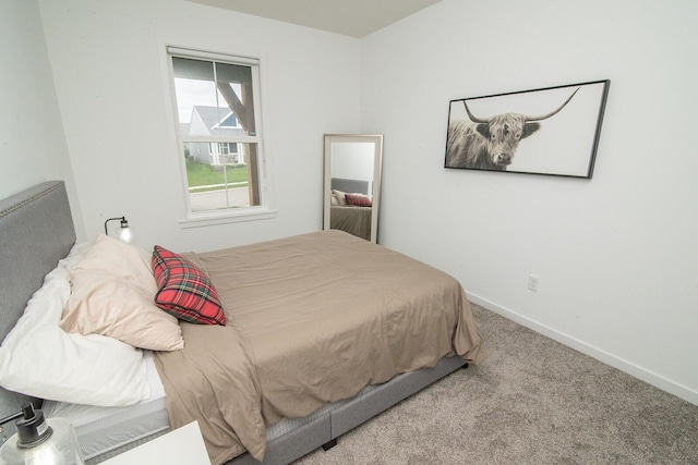 carpeted bedroom featuring baseboards