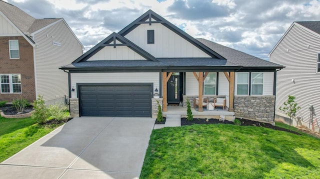 view of front of house with a porch, an attached garage, board and batten siding, a front lawn, and driveway