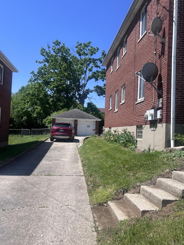 459 Commonwealth Ave, Erlanger, KY 41018 - view of side of home featuring a garage, brick siding, and a lawn