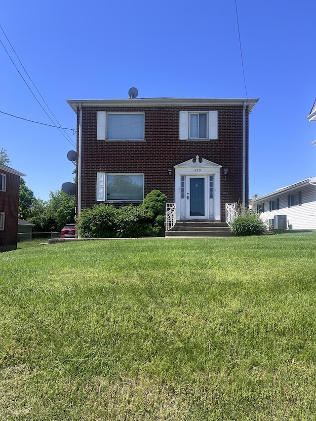 459 Commonwealth Ave, Erlanger, KY 41018 - colonial house featuring brick siding, a front lawn, and central AC unit