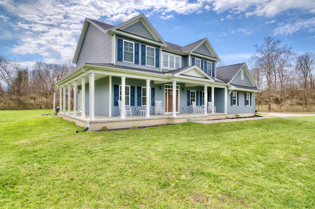 view of front facade with covered porch and a front yard