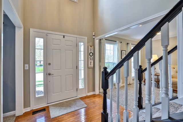11506 Sutherland Dr, Walton, KY 41094 - foyer featuring light wood-type flooring, visible vents, stairs, and ornamental molding