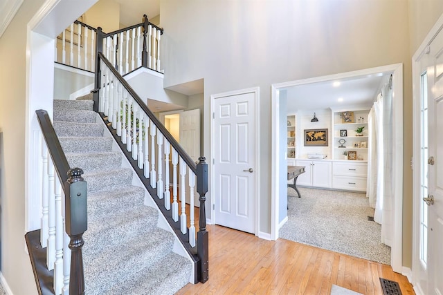 11506 Sutherland Dr, Walton, KY 41094 - staircase with hardwood / wood-style floors, baseboards, a towering ceiling, and visible vents