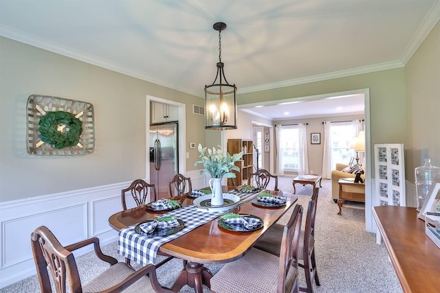 11506 Sutherland Dr, Walton, KY 41094 - dining room with a wainscoted wall, visible vents, a decorative wall, crown molding, and light colored carpet