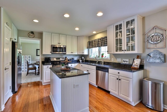 11506 Sutherland Dr, Walton, KY 41094 - kitchen with light wood-type flooring, stainless steel appliances, a sink, and white cabinetry
