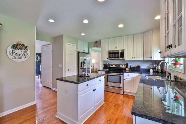 11506 Sutherland Dr, Walton, KY 41094 - kitchen with light wood-style flooring, a sink, white cabinetry, a kitchen island, and appliances with stainless steel finishes