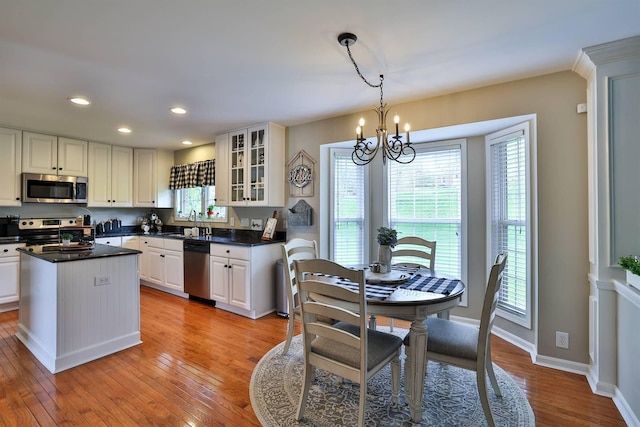 11506 Sutherland Dr, Walton, KY 41094 - kitchen featuring glass insert cabinets, stainless steel appliances, light wood-style flooring, a notable chandelier, and recessed lighting