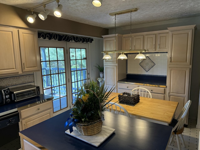 kitchen with track lighting, black dishwasher, a textured ceiling, decorative backsplash, and a toaster
