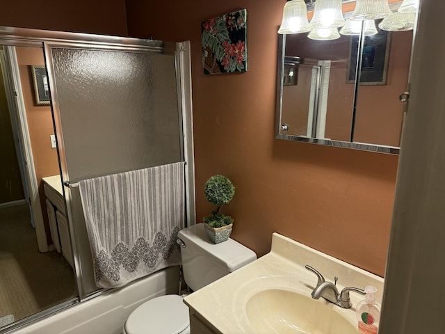 full bath featuring toilet, vanity, and combined bath / shower with glass door