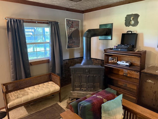living area with a textured ceiling, a wood stove, and carpet floors
