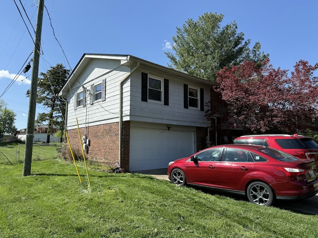 view of home's exterior with an attached garage, a lawn, fence, and brick siding