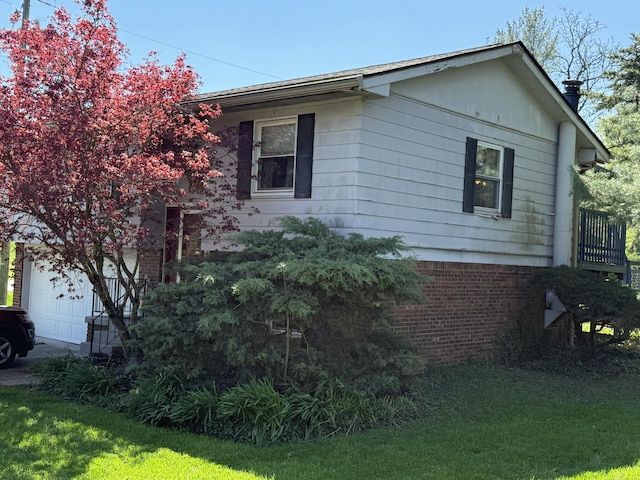view of home's exterior with brick siding and a yard