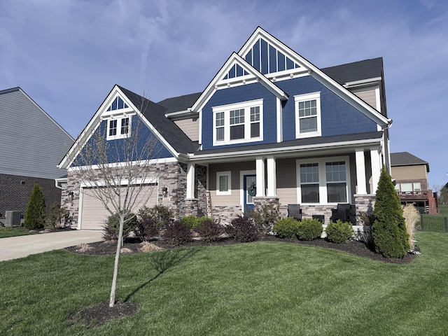 craftsman house with cooling unit, driveway, stone siding, and a front yard