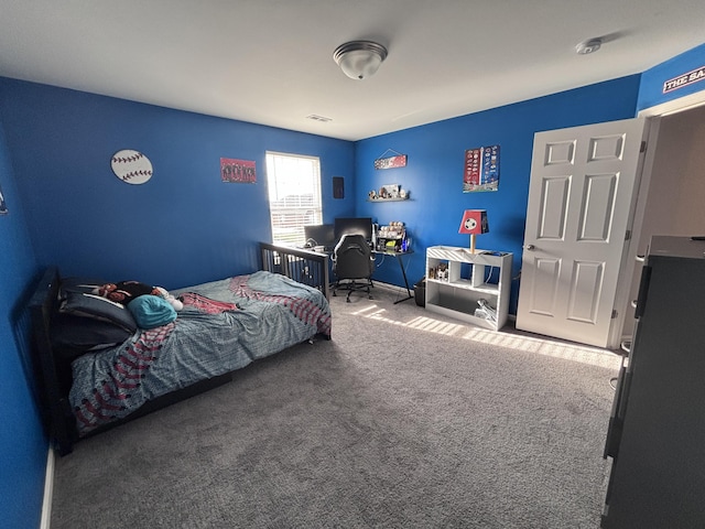 carpeted bedroom featuring visible vents