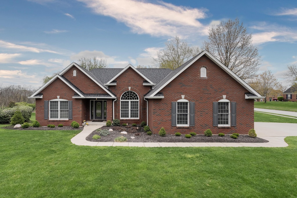 view of front of property with brick siding and a front yard