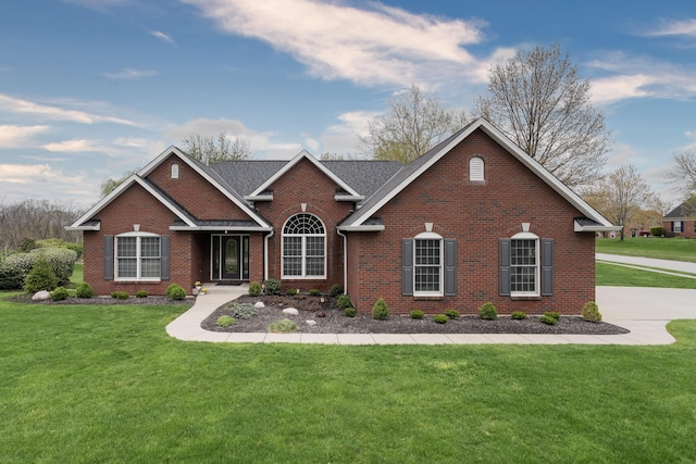 view of front of property with brick siding and a front yard