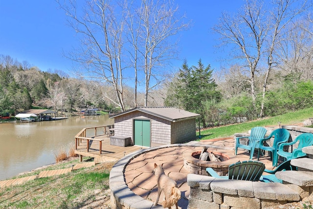 445 Elk Lake Resort Rd Unit 947-948, Owenton, KY 40359 - view of patio / terrace featuring a fire pit, a deck with water view, and an outbuilding