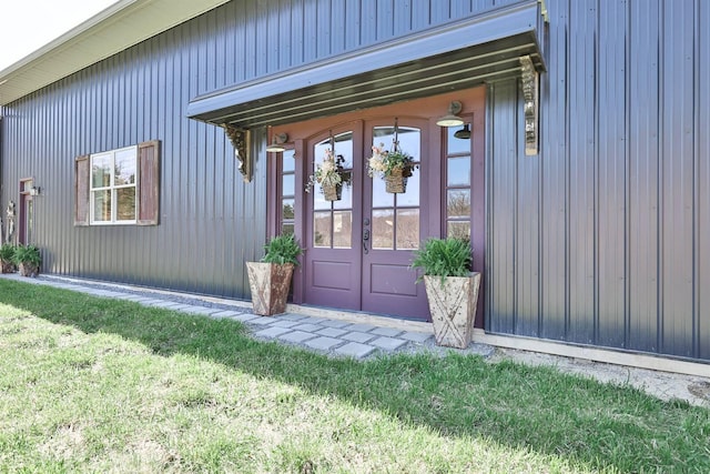 entrance to property featuring french doors and a yard