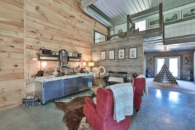 living room featuring wooden walls and finished concrete flooring