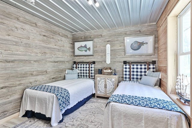 bedroom featuring wooden walls
