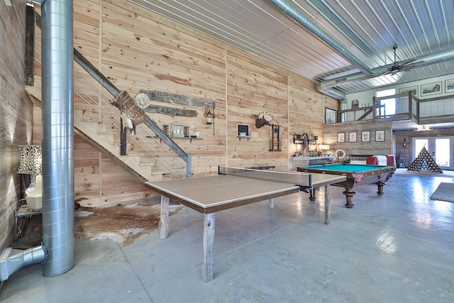 game room with wooden walls, billiards, and finished concrete floors