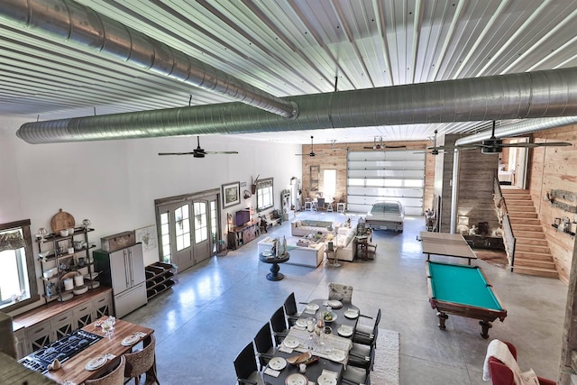 interior space with ceiling fan, concrete flooring, pool table, and plenty of natural light