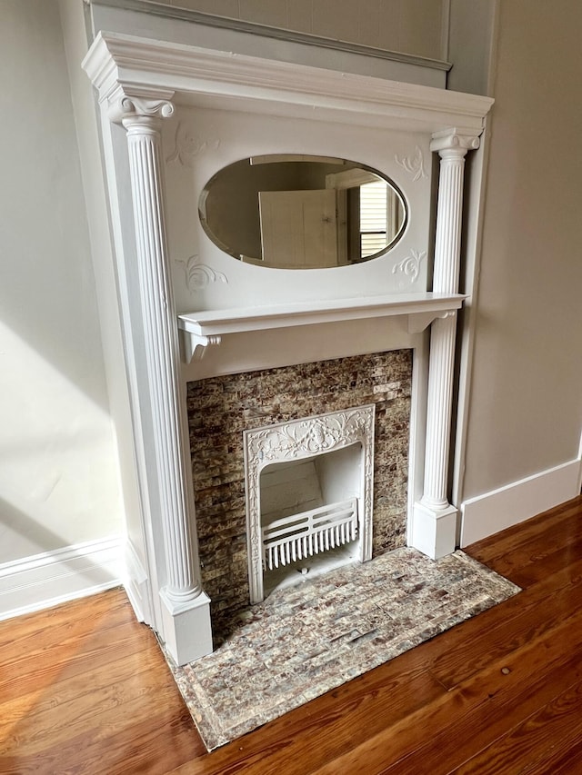 626 W 12th St, Covington, KY 41011 - detailed view of baseboards, wood finished floors, decorative columns, and a fireplace