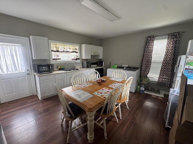 dining area featuring washing machine and clothes dryer and dark wood-style flooring