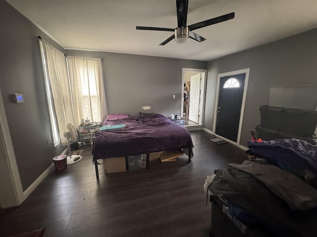 bedroom with wood finished floors, baseboards, and ceiling fan