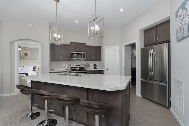 692 Daphne Way, Crescent Springs, KY 41017 - kitchen featuring appliances with stainless steel finishes, a sink, dark brown cabinetry, light countertops, and baseboards