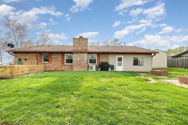 rear view of property with fence private yard, a chimney, and a yard