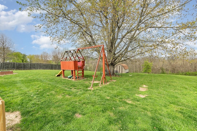 view of yard with fence and a playground