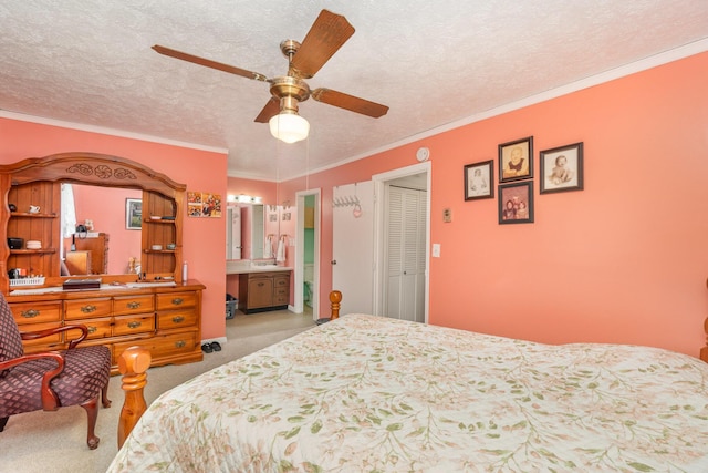 bedroom with ensuite bathroom, carpet flooring, a textured ceiling, and ornamental molding