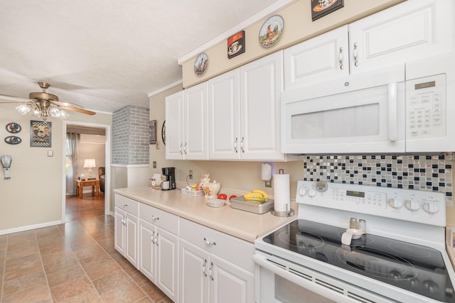 kitchen with white cabinets, light countertops, white appliances, baseboards, and ceiling fan