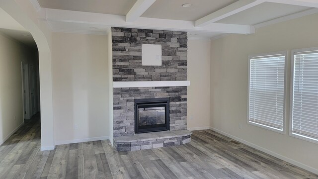 3879 US Highway 27 N, Cynthiana, KY 41031 - unfurnished living room with arched walkways, wood finished floors, beam ceiling, and a fireplace