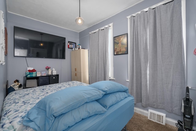 carpeted bedroom featuring visible vents