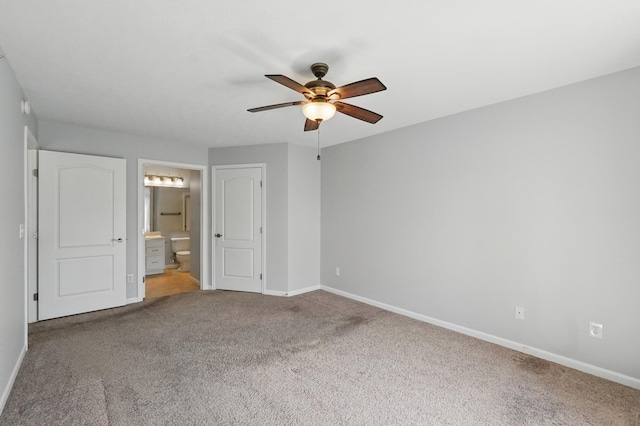 unfurnished bedroom featuring carpet floors, connected bathroom, and baseboards