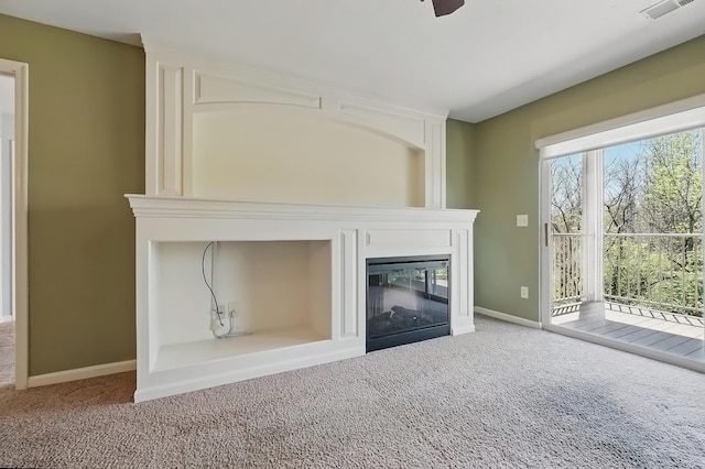 unfurnished living room featuring baseboards, carpet, visible vents, and a fireplace